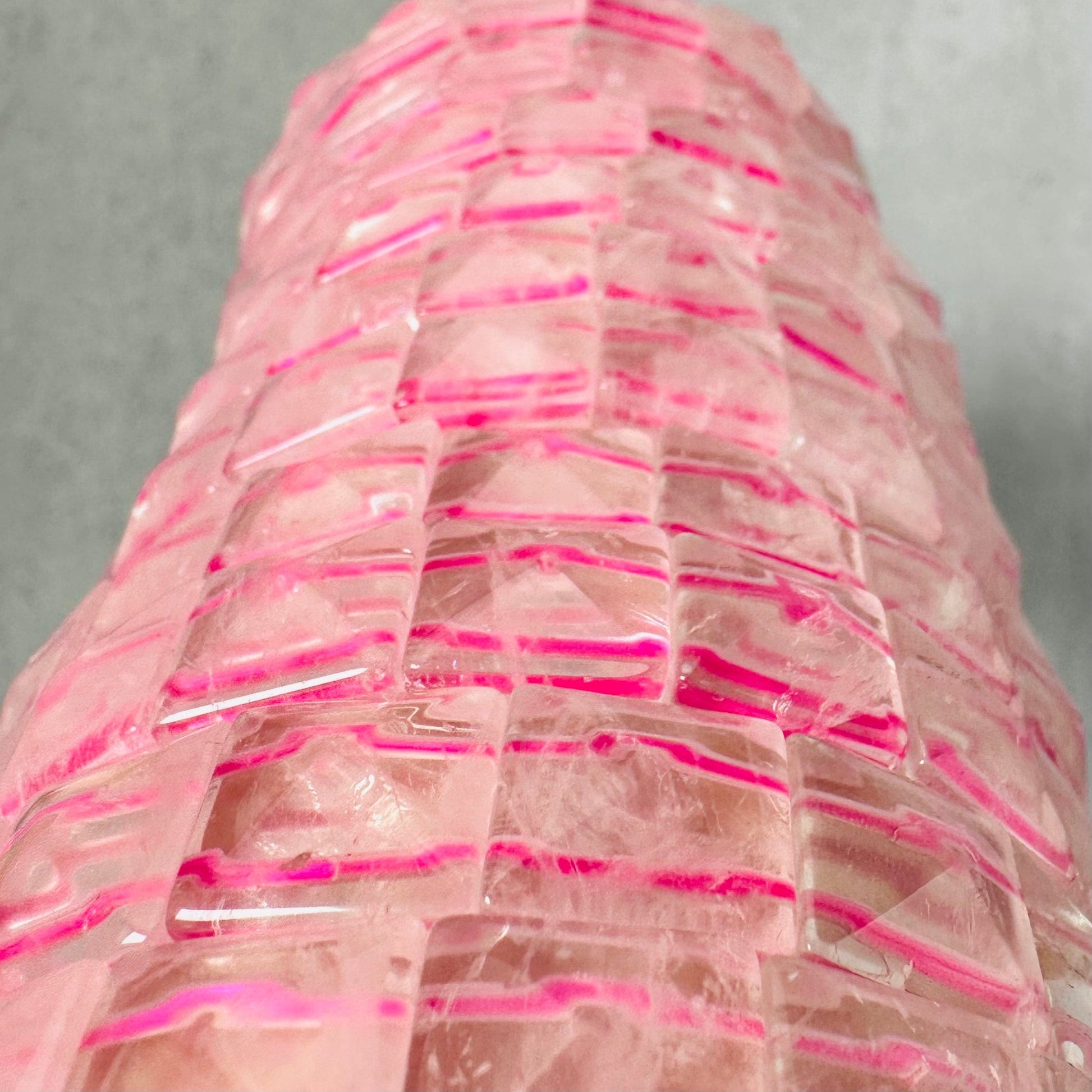Up close view of various Rose Quartz Square Bead Bracelets.
