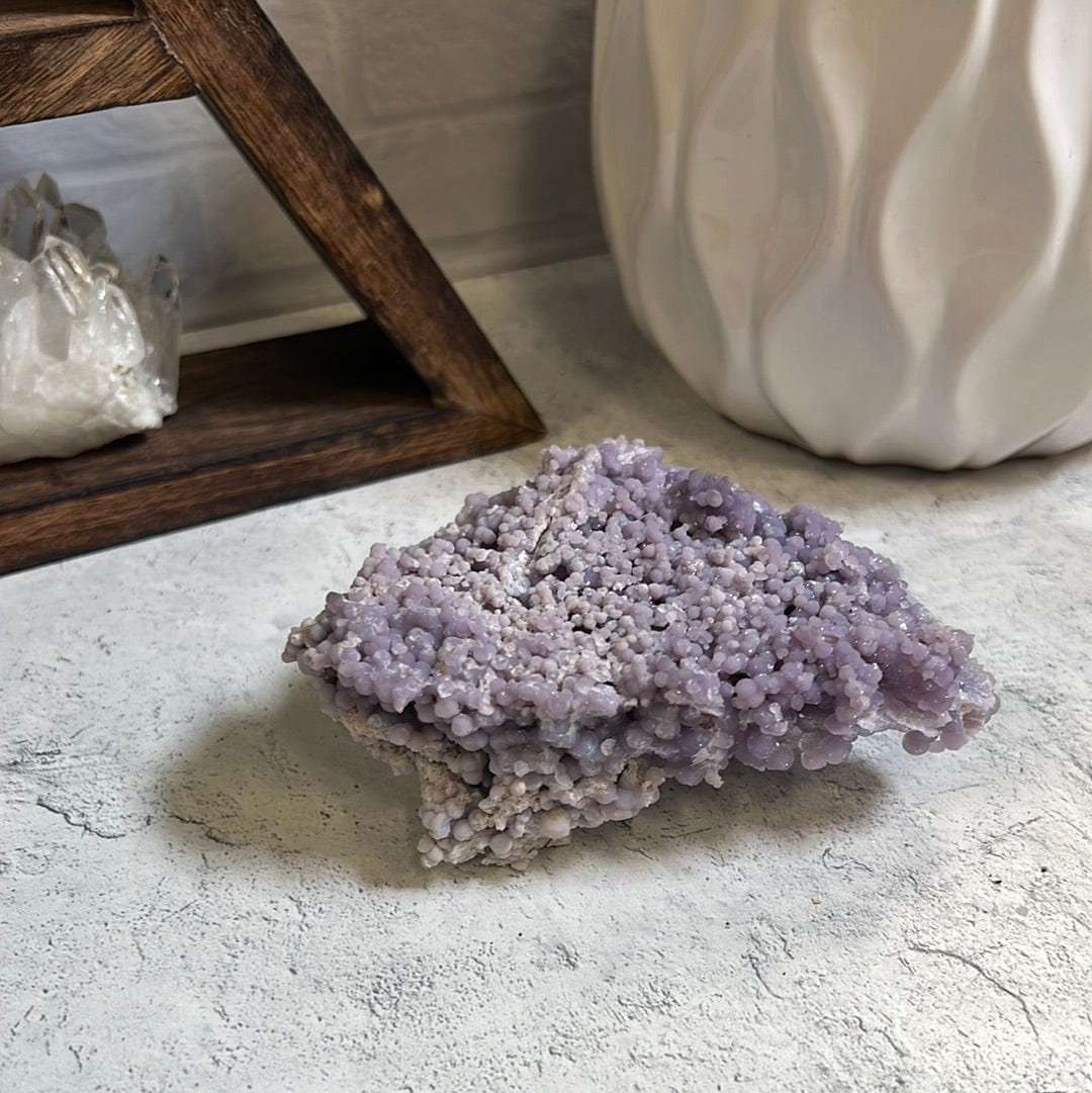 Grape agate on a cement background.