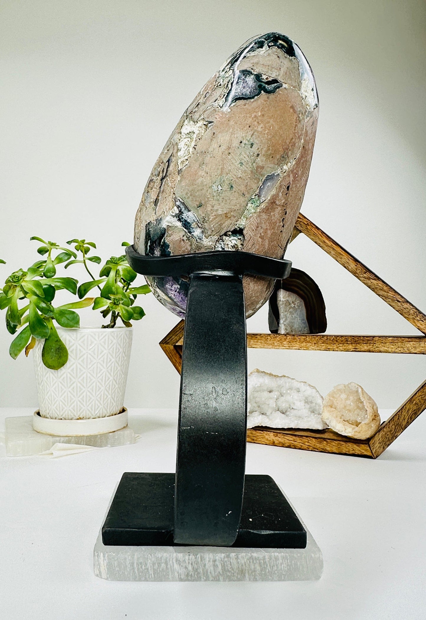 amethyst on metal stand with decorations in the background