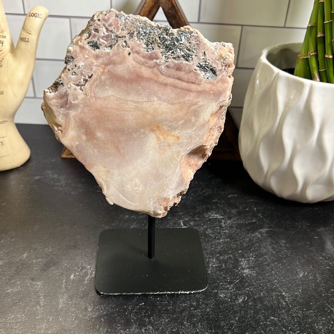 Pink amethyst slab on a black metal stand