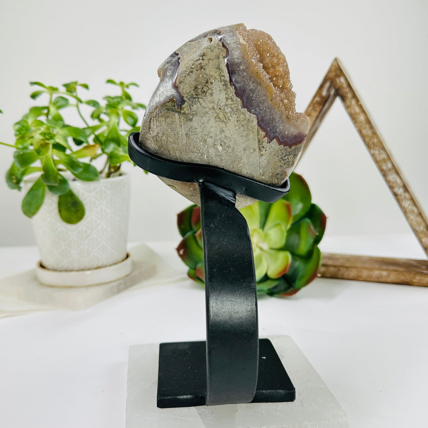 amethyst on metal stand with decorations in the background
