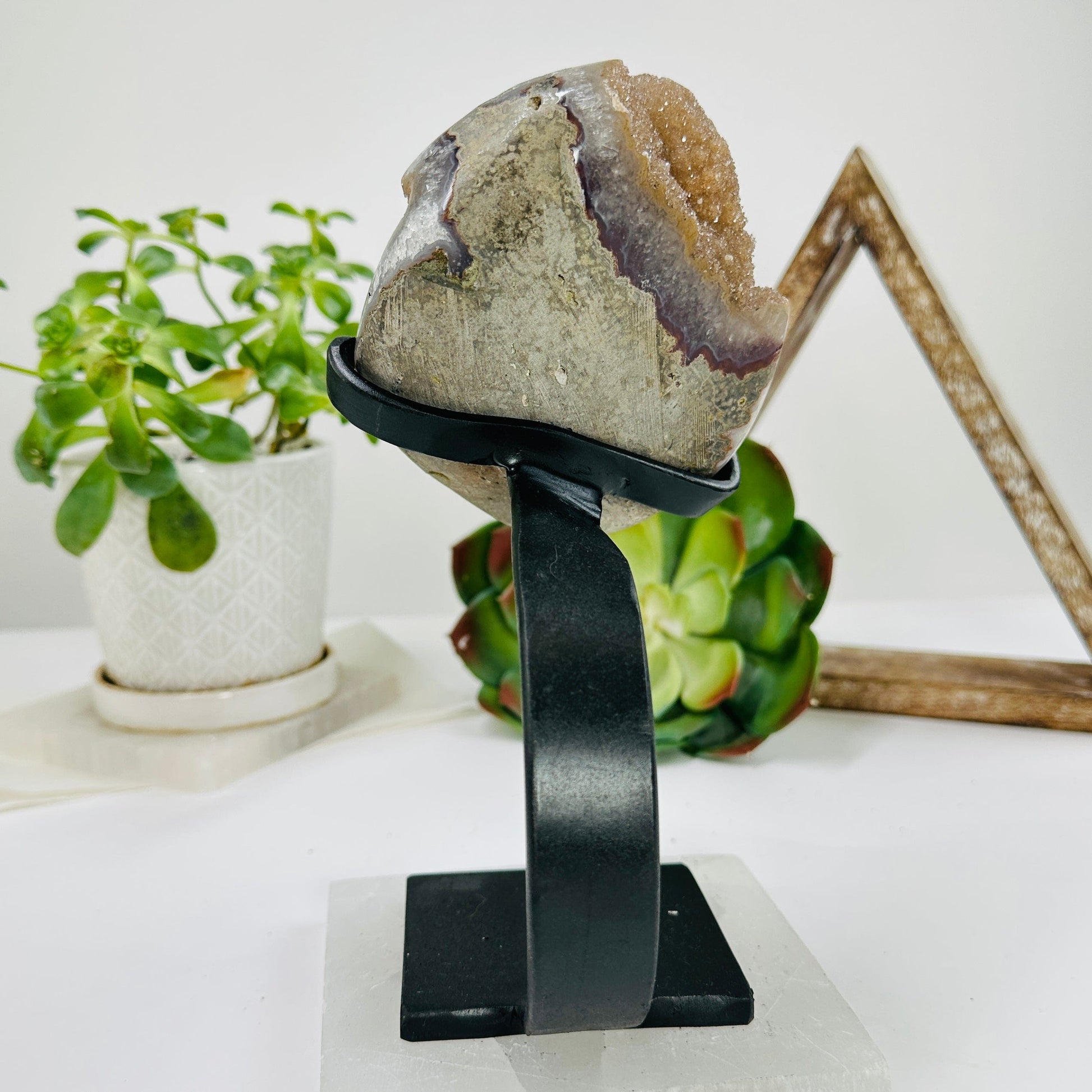 amethyst on metal stand with decorations in the background