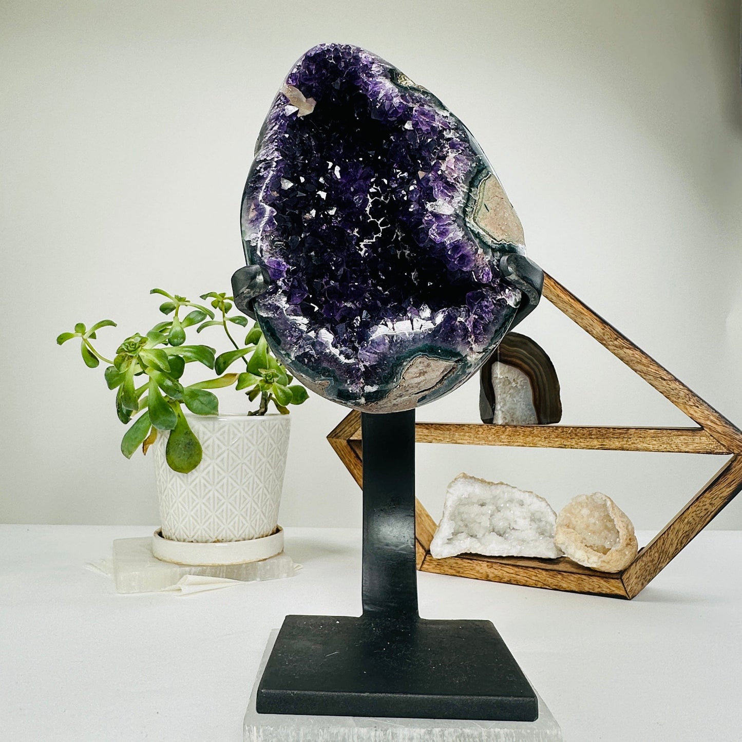 amethyst on metal stand with decorations in the background
