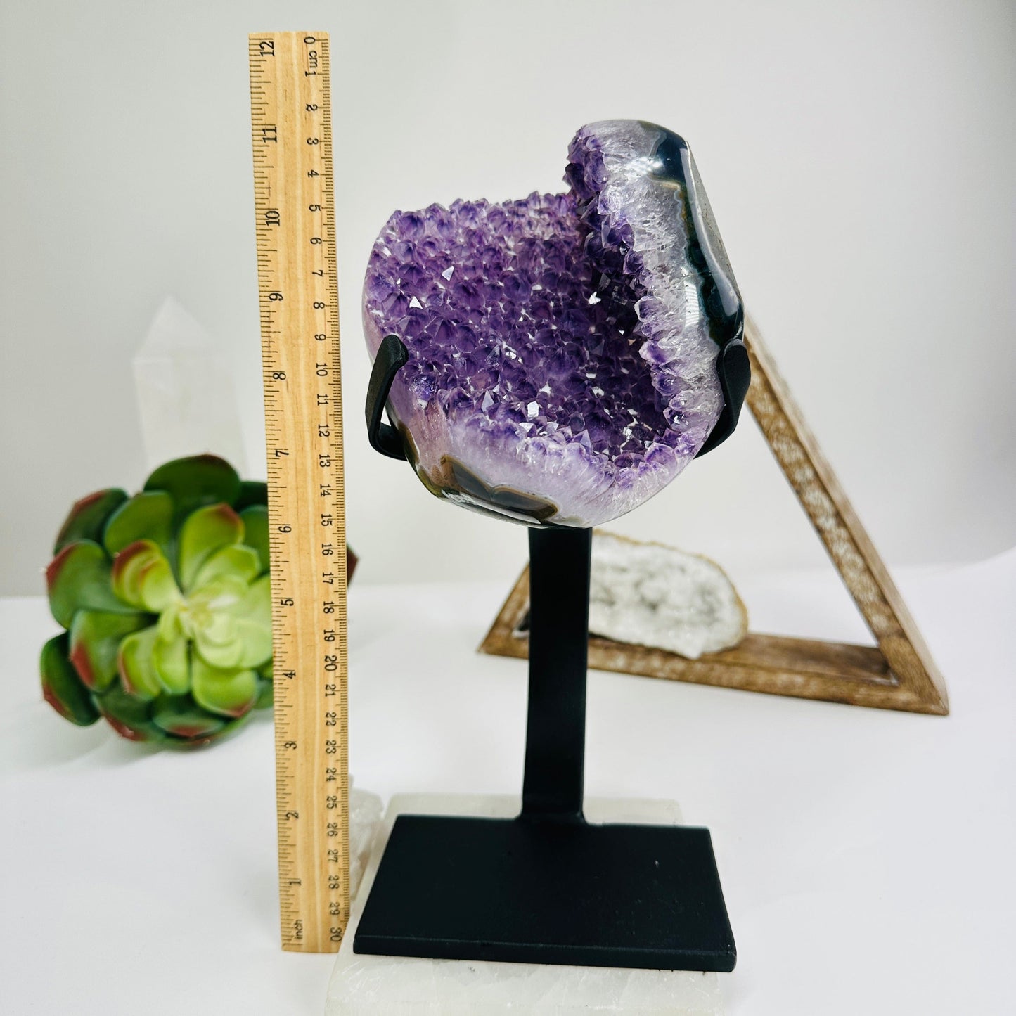 amethyst with stand next to a ruler for size reference