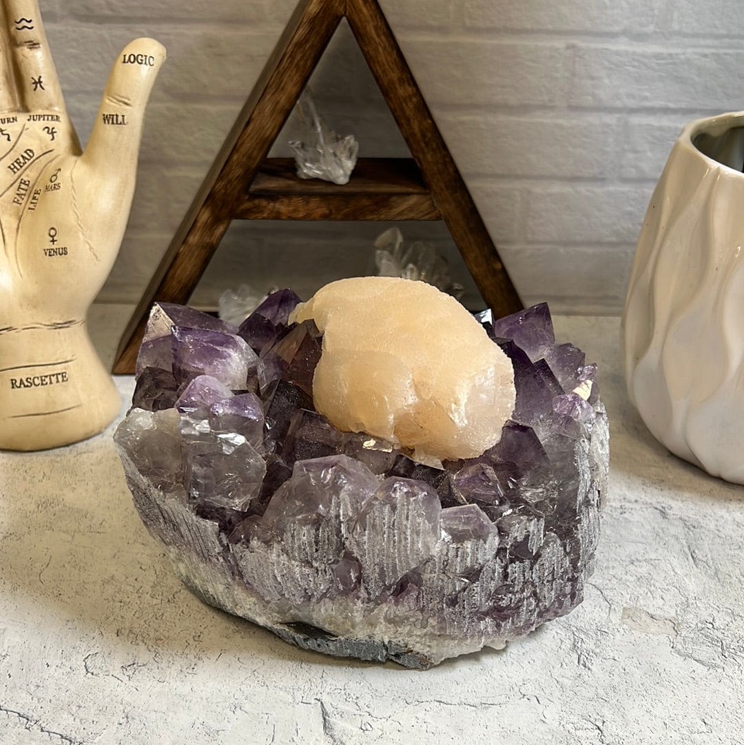Large high quality purple amethyst cluster with a large cream color calcite formation around the center of it.