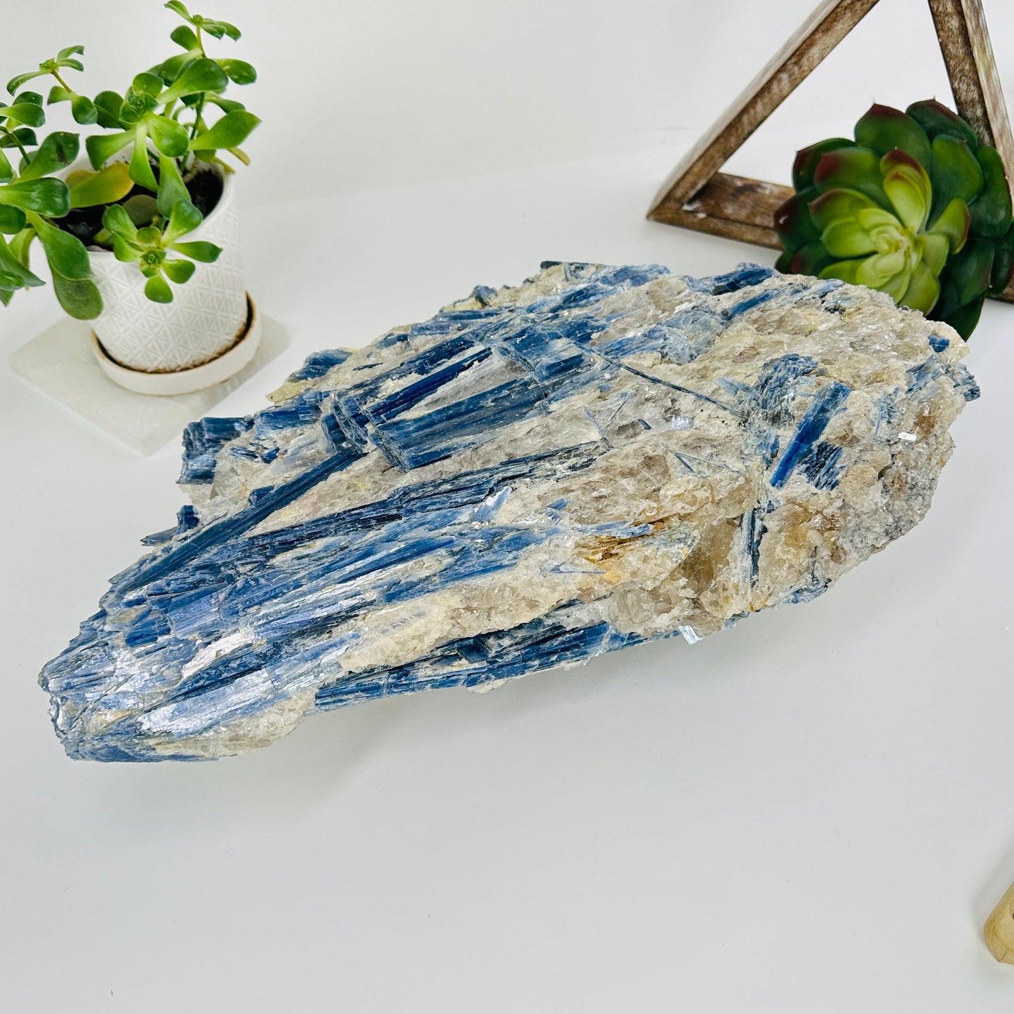 massive kyanite cluster with decorations in the background
