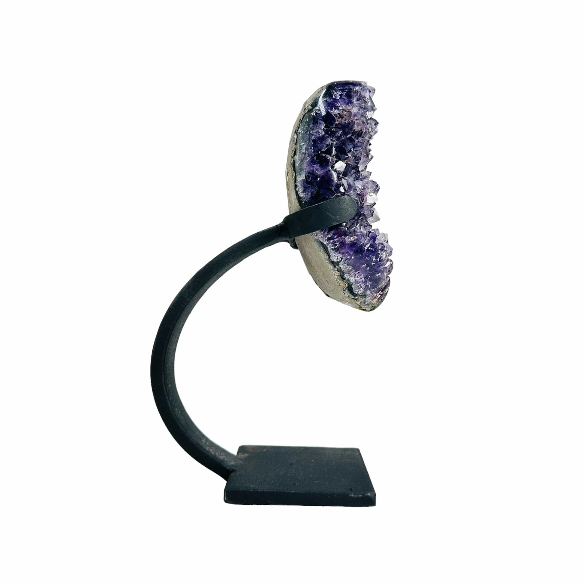 side view of amethyst with stand on white background