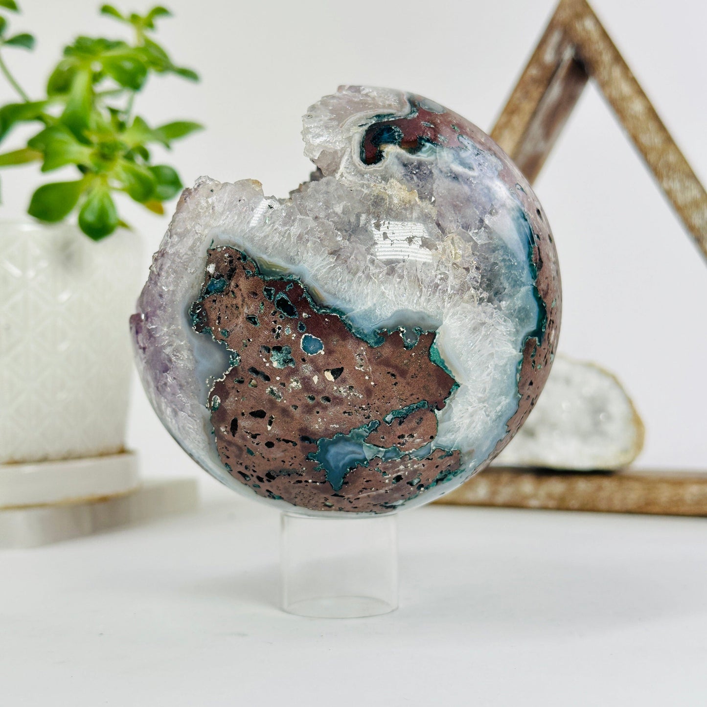 amethyst druzy sphere with decorations in the background