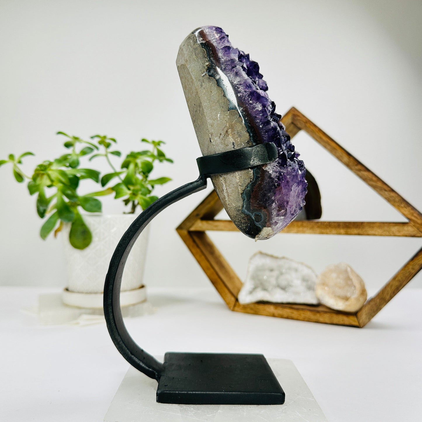amethyst on metal stand with decorations in the background