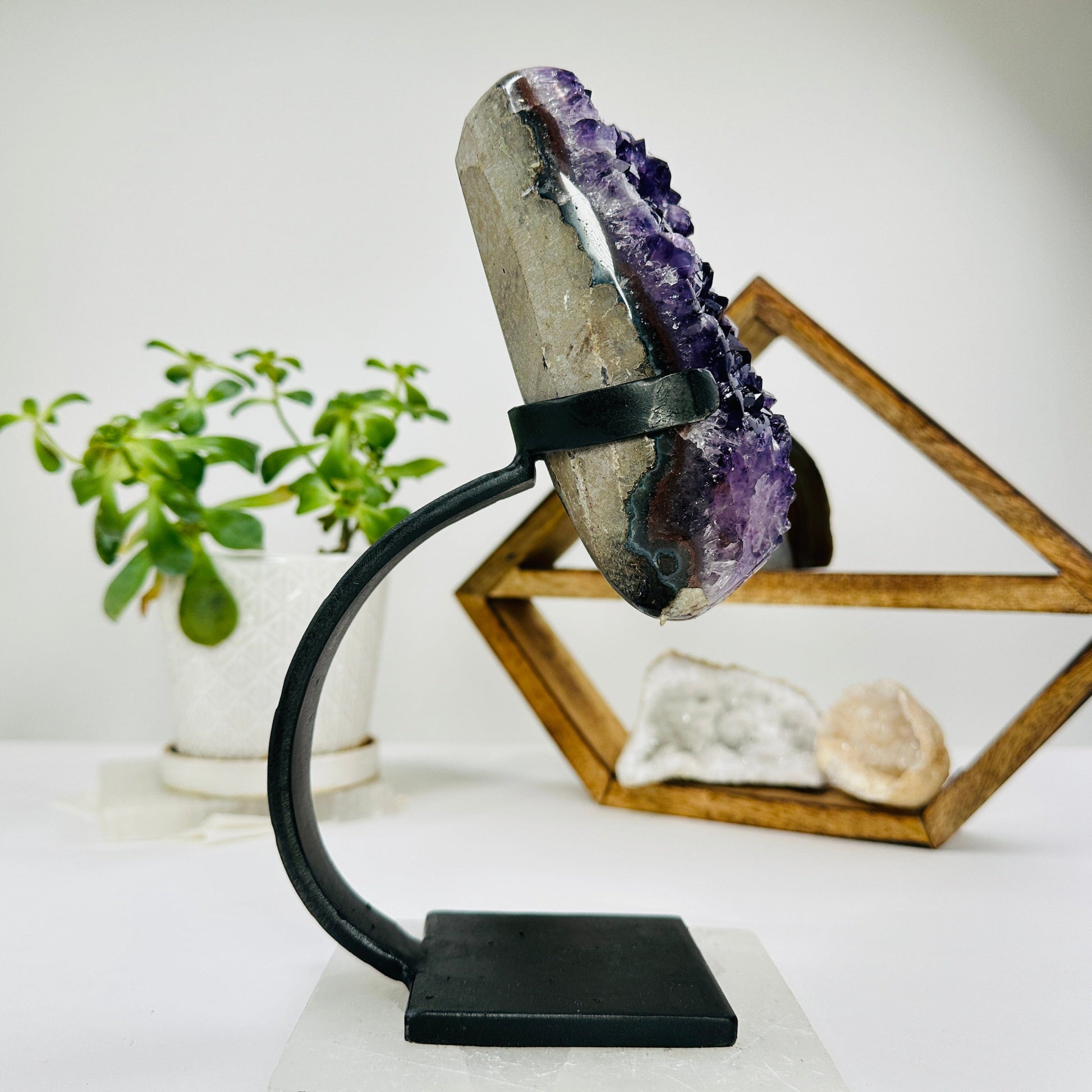 amethyst on metal stand with decorations in the background