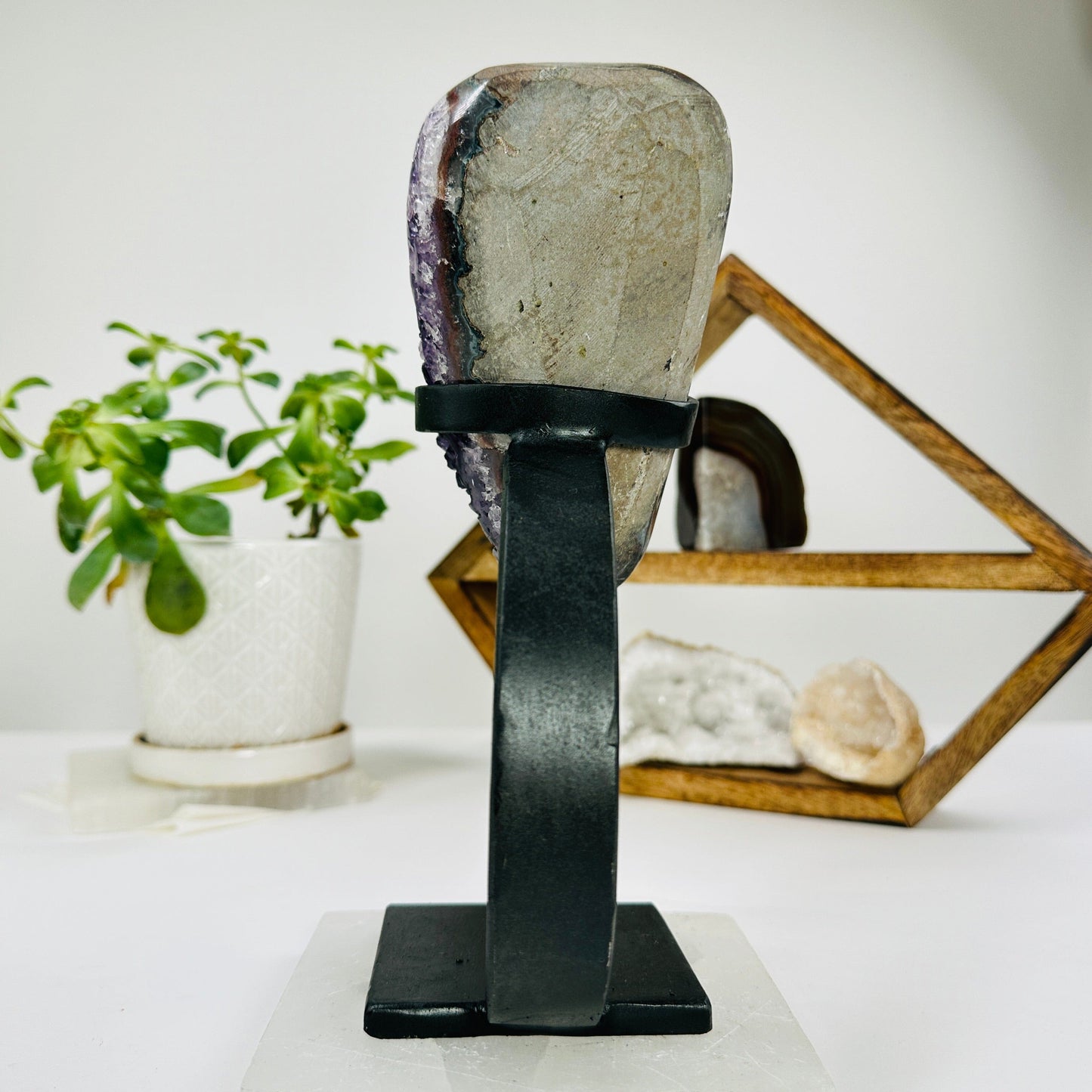 amethyst on metal stand with decorations in the background