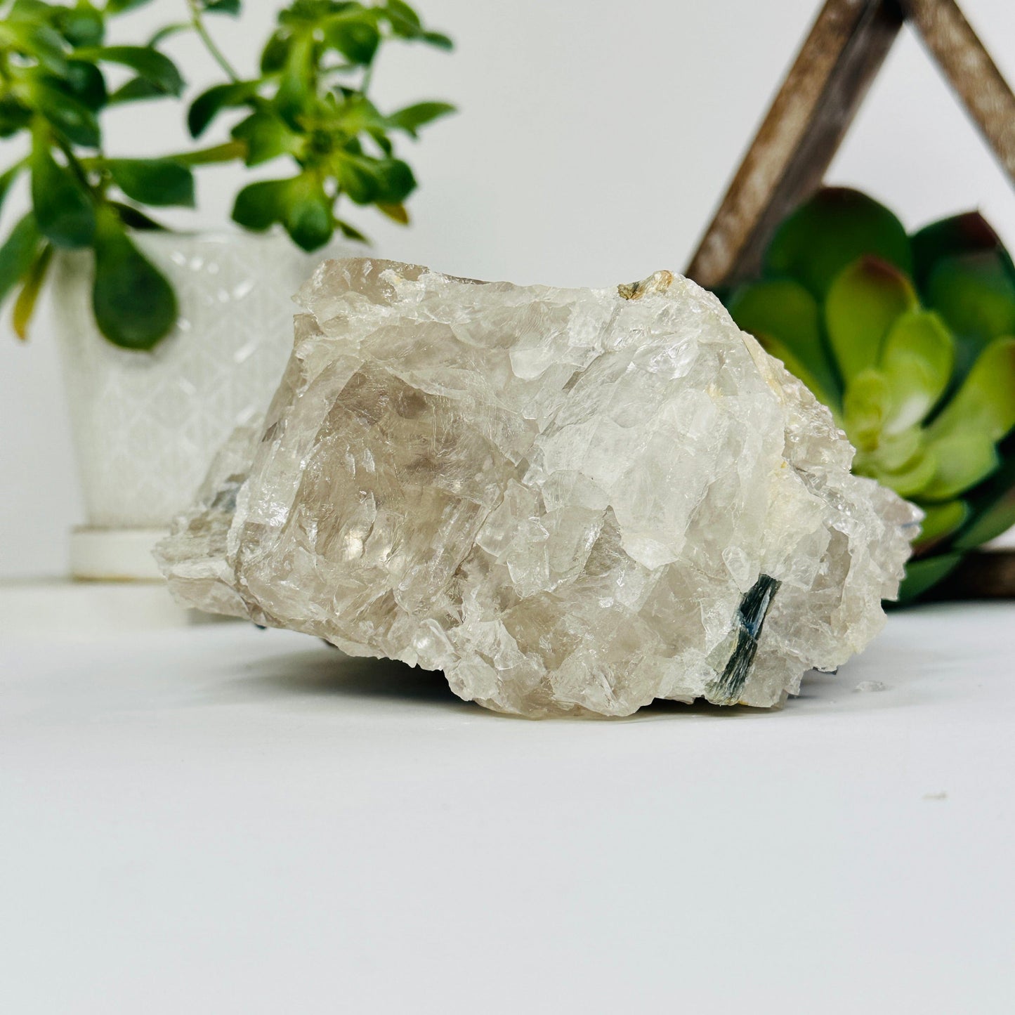 blue kyanite on matrix with decorations in the background