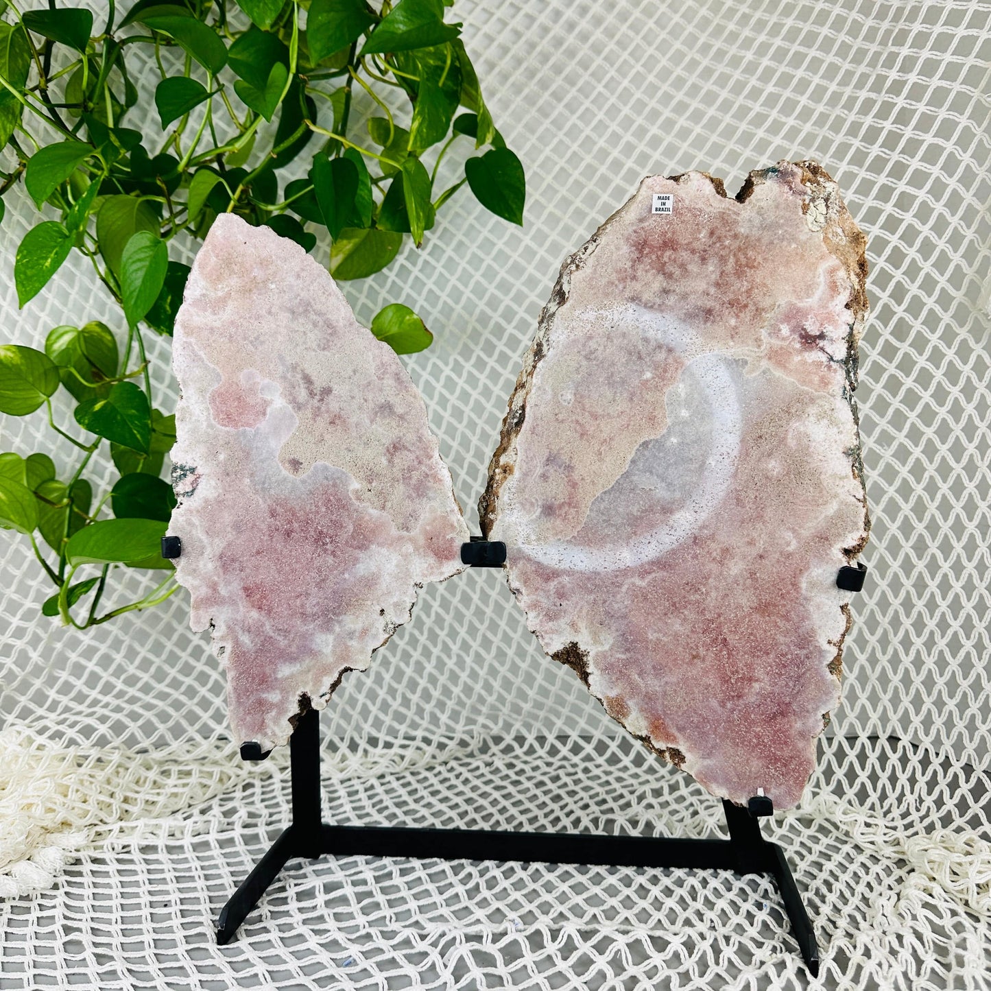 Pink amethyst wings with decorations in the background