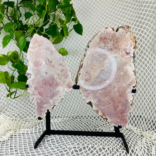 Pink amethyst wings with decorations in the background