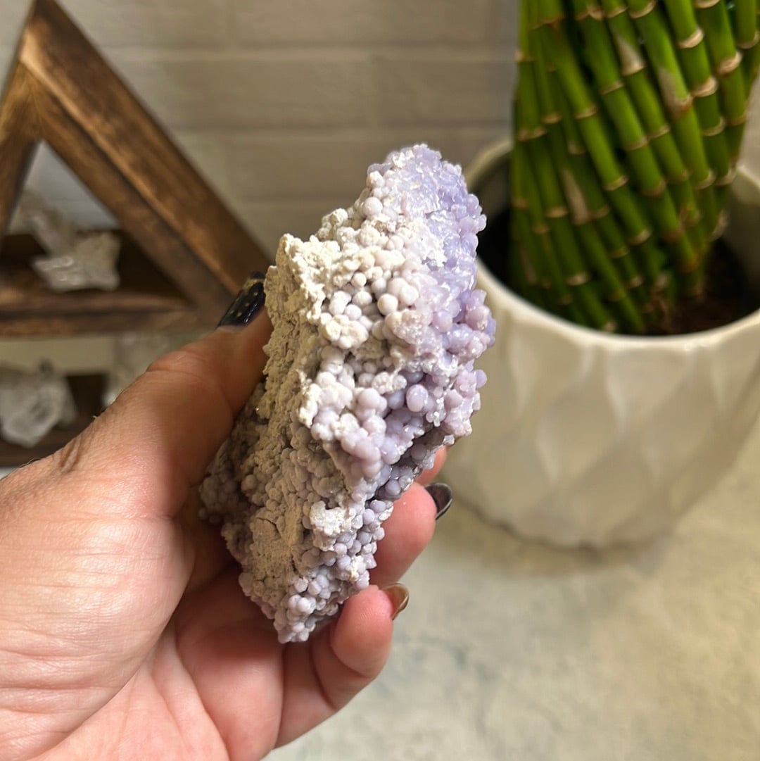 Grape agate formation in a woman's hand.
