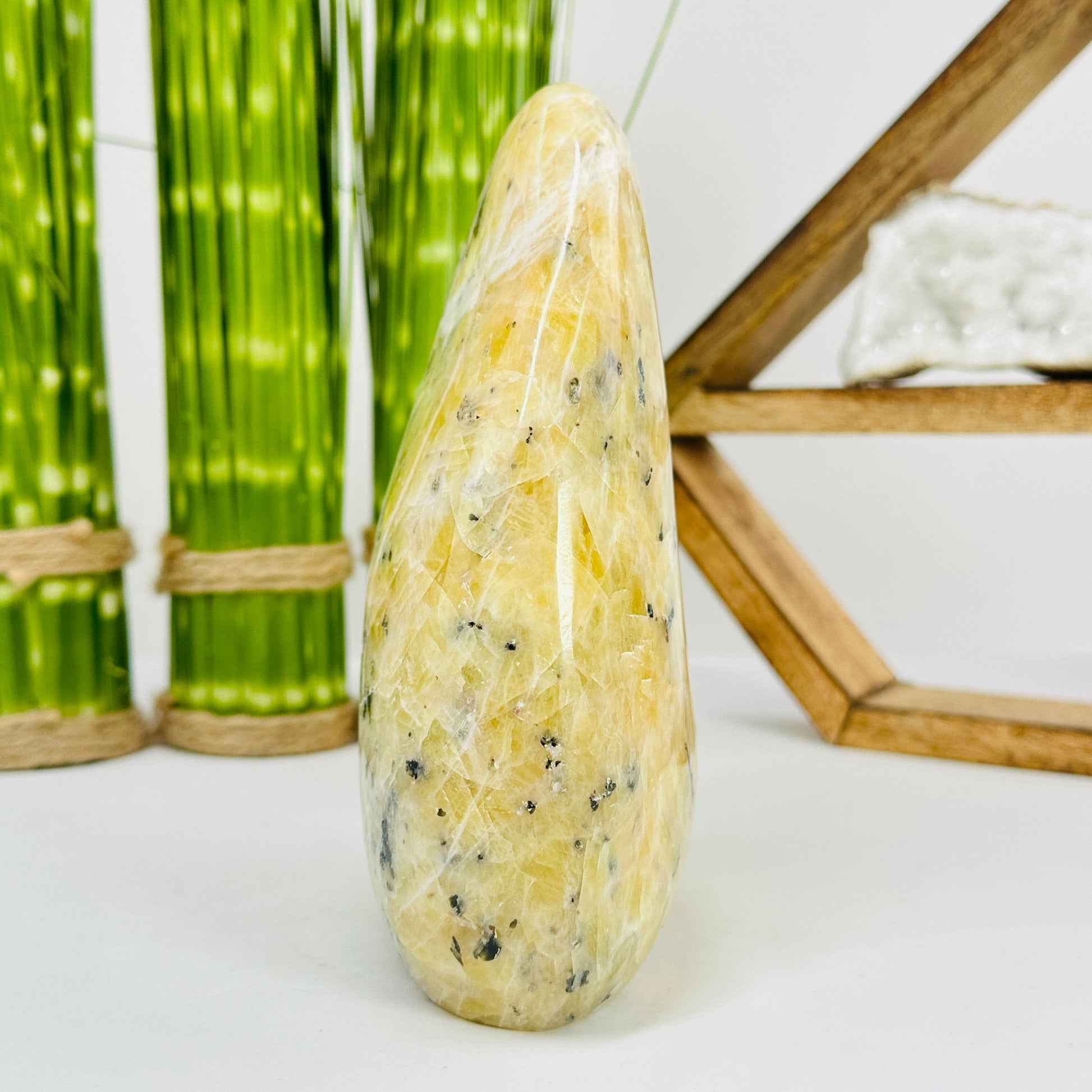side view of dendrite opal cut base with decorations in the background