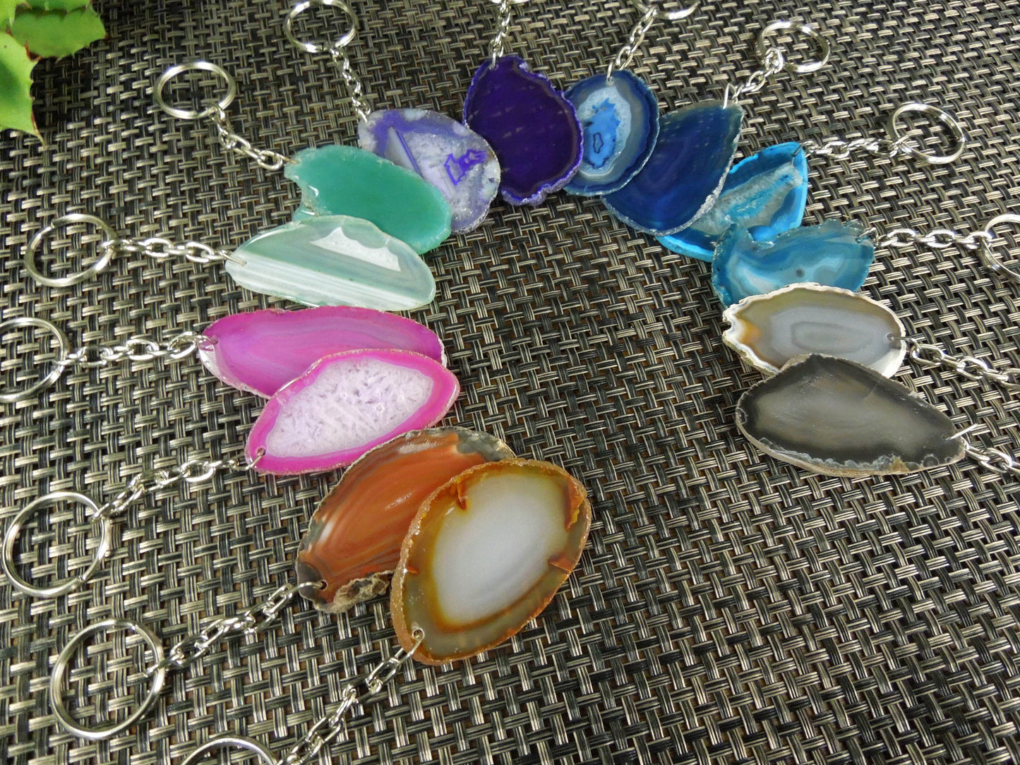 Multiple agate keychains on a dark colored background