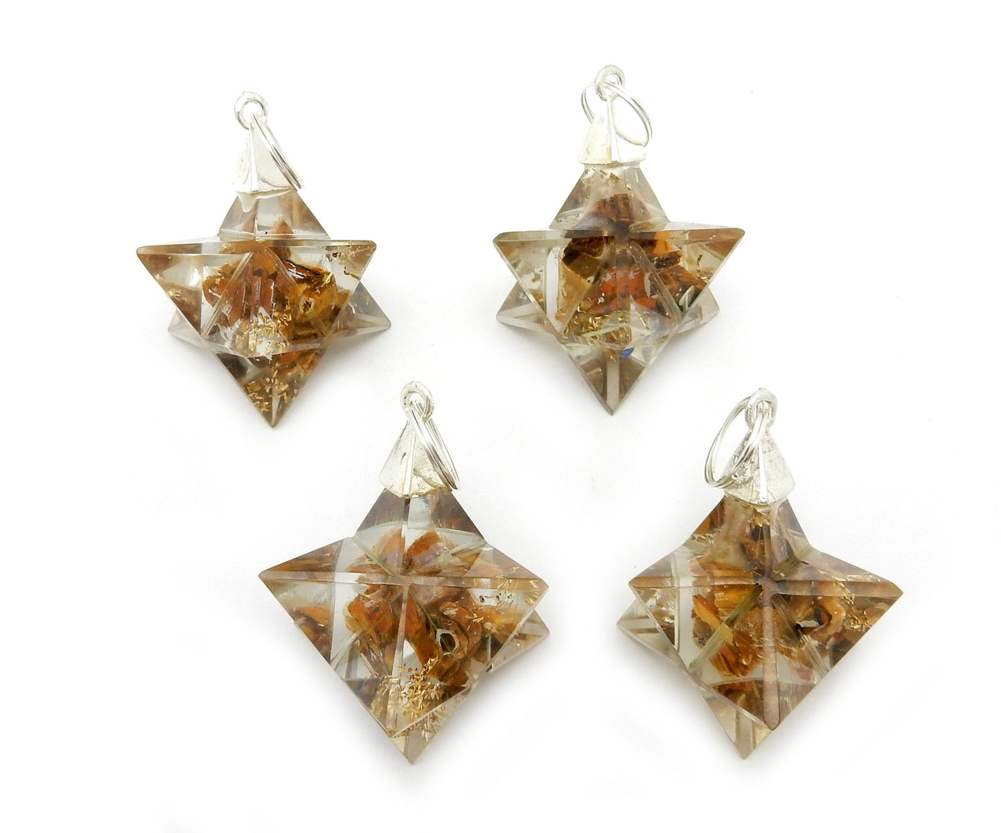 Merkaba - Merkaba Star Orgone Silver Toned Bail Pendant on a table