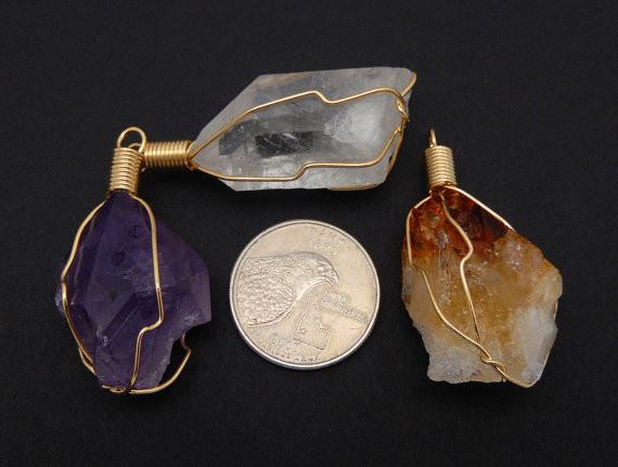 pendants next to a quarter for size reference 