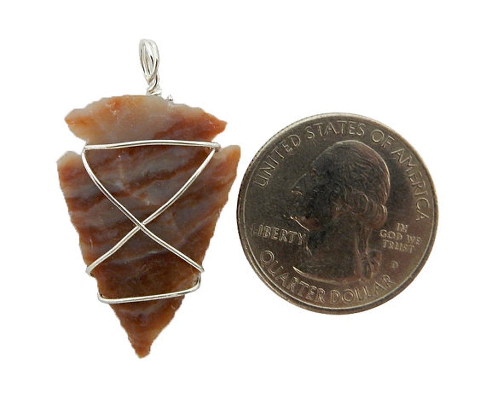 Jasper Arrowhead Pendant next to a quarter