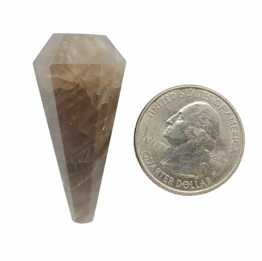 smoky quartz pendulum next to a quarter