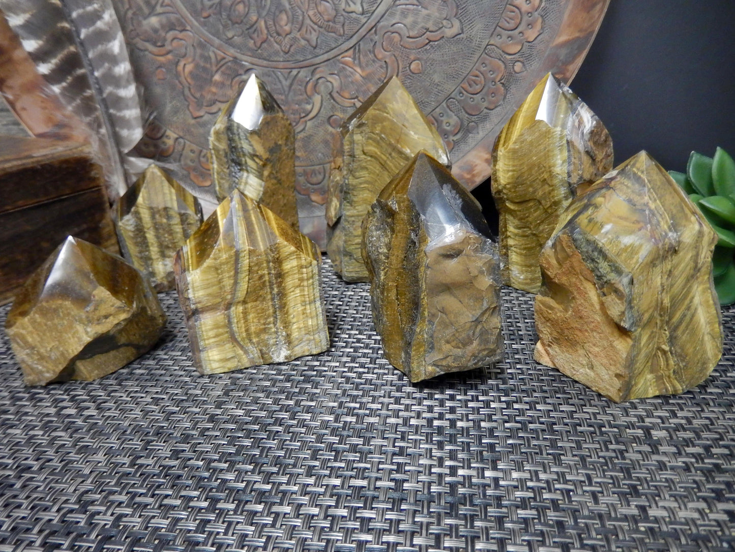 assorted tiger semi polished points on a brown background.