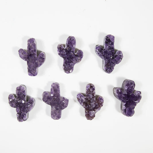 multiple amethyst cactus cabochons displayed to show the differences in the color shades 