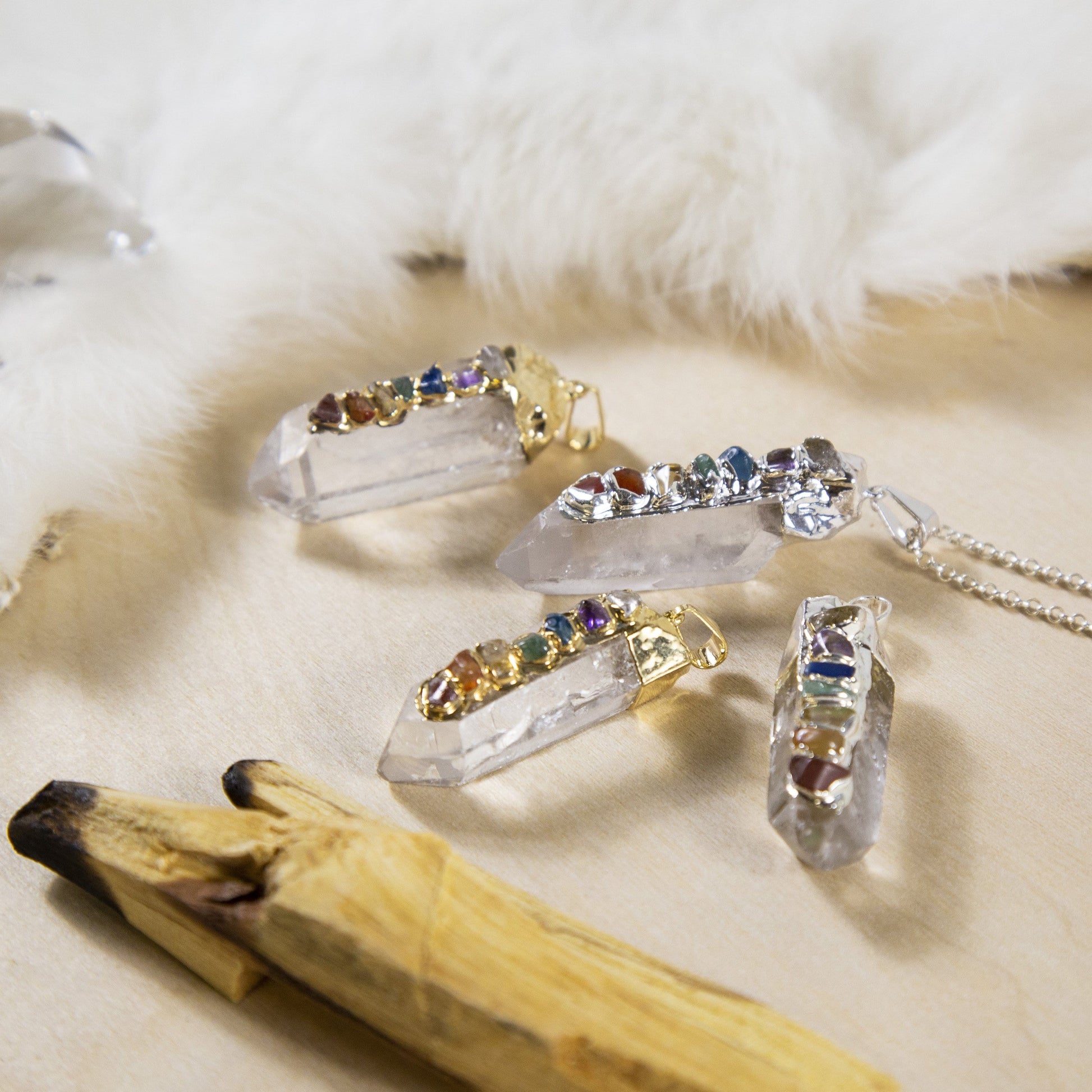 angled shot of 4 Crystal Quartz Point Pendants with decorations