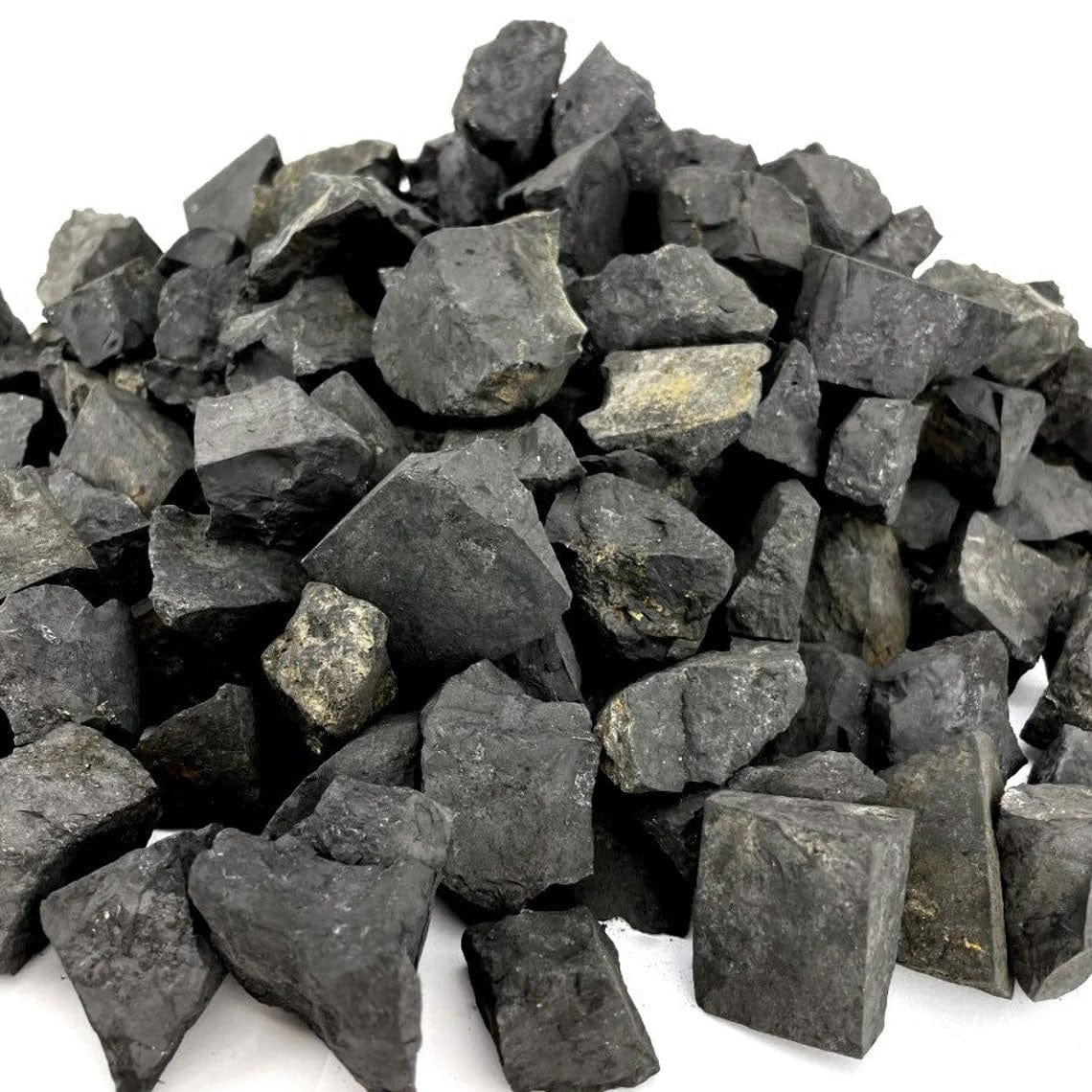 close up of many shungite natural stones in a pile for details