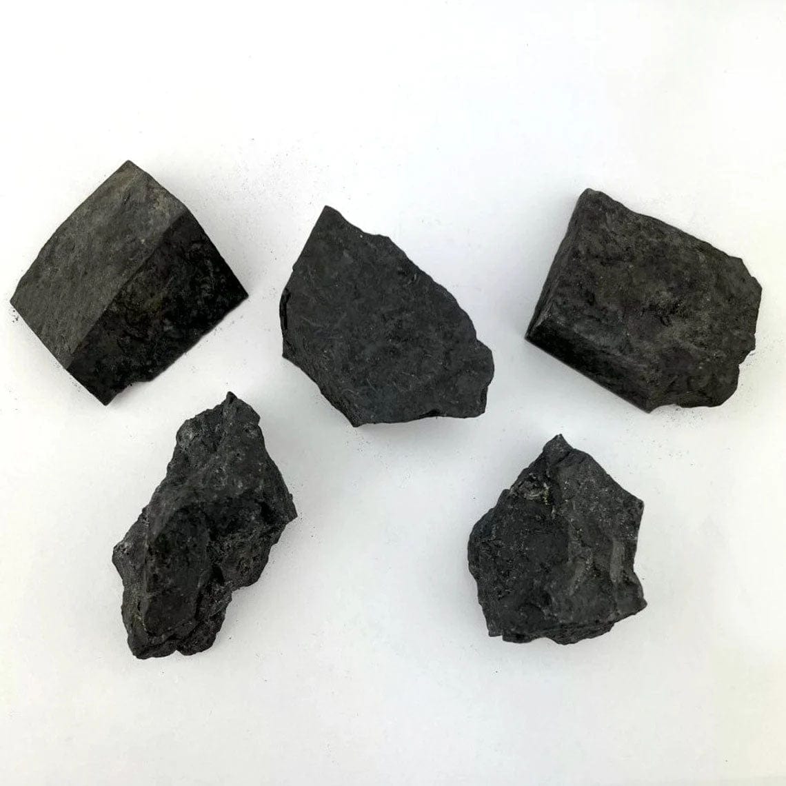 five shungite natural stones on white background