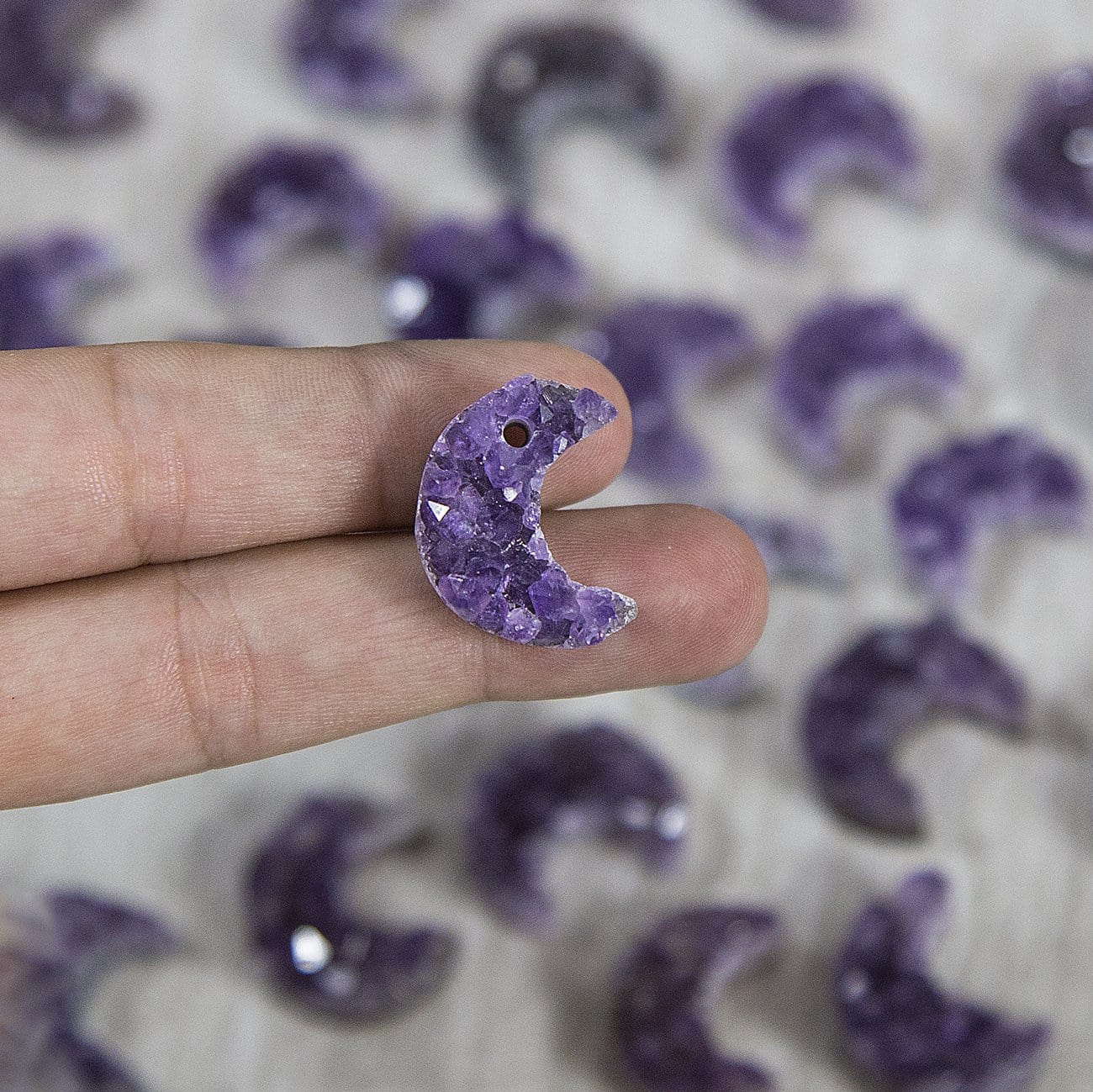 One amethyst moon in a woman's hand.