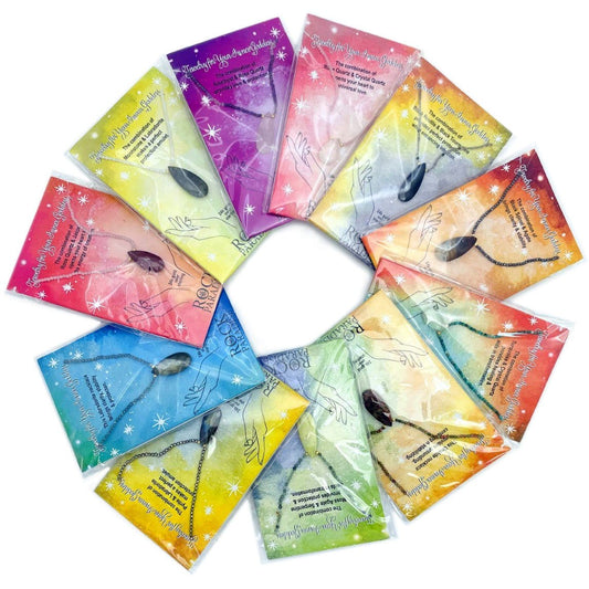 a bunch of necklaces on cards arranged in a circle on a table