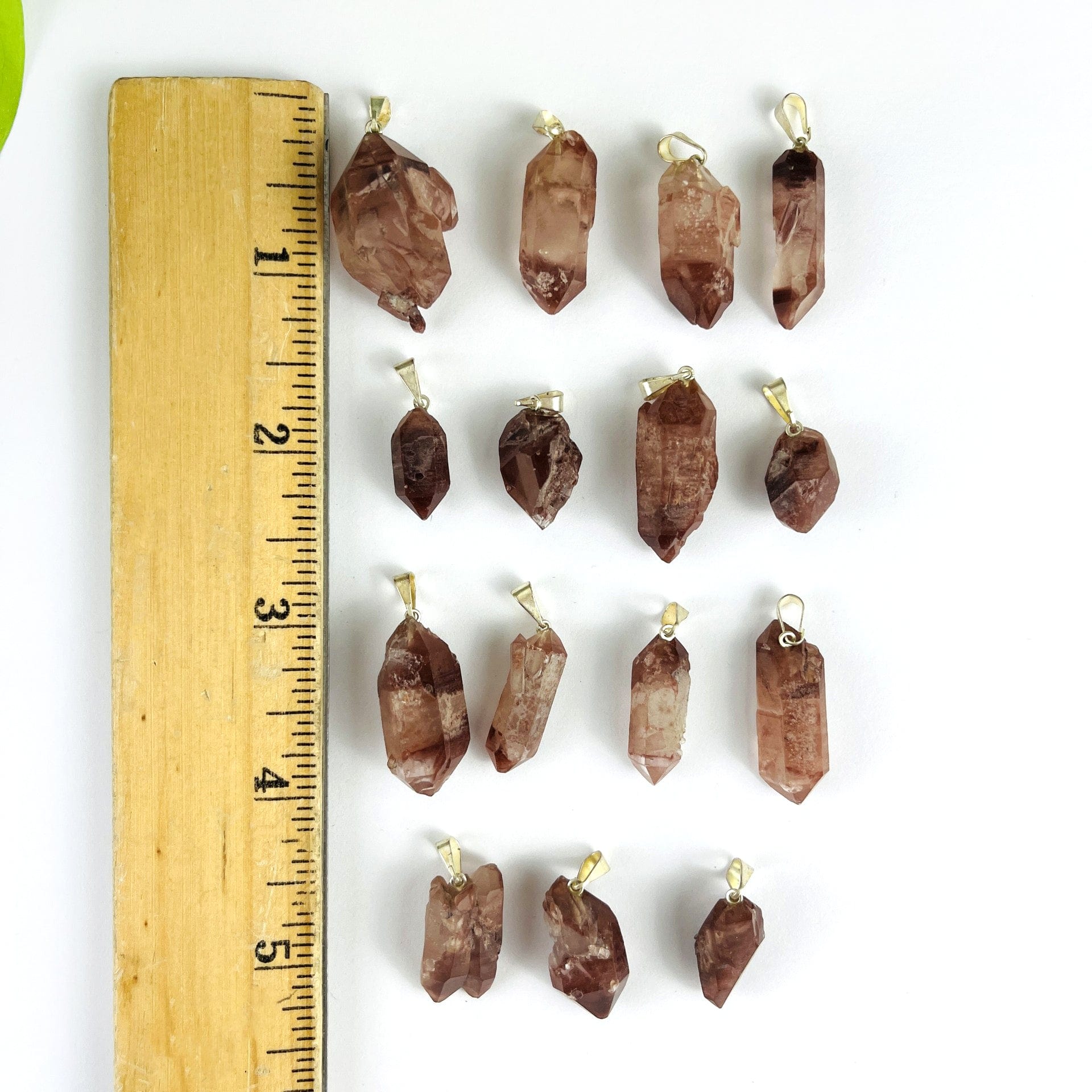Lithium Crystal Point Pendants with Silver Bail next to a ruler showing size