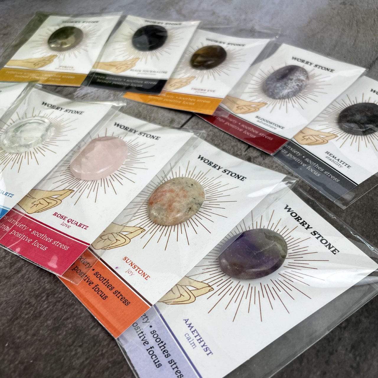 Worry Stone on Card in Protective Sleeve fanned out on a table side view