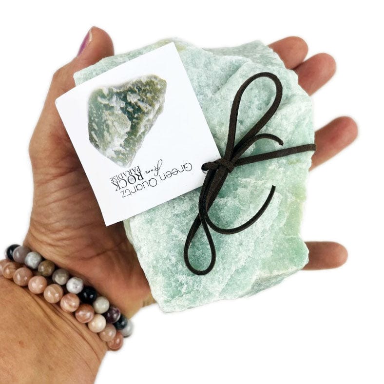 a 1-2 kilos size green quartz in a hand for size