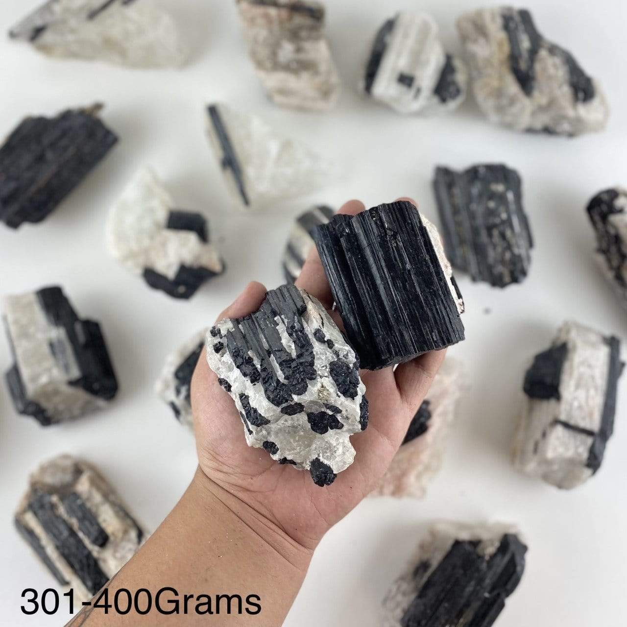 black tourmaline on matrix displayed in hand size is for 301-400 grams