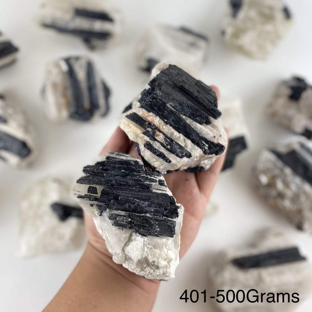 black tourmaline on matrix displayed in hand size is for 401-500 grams
