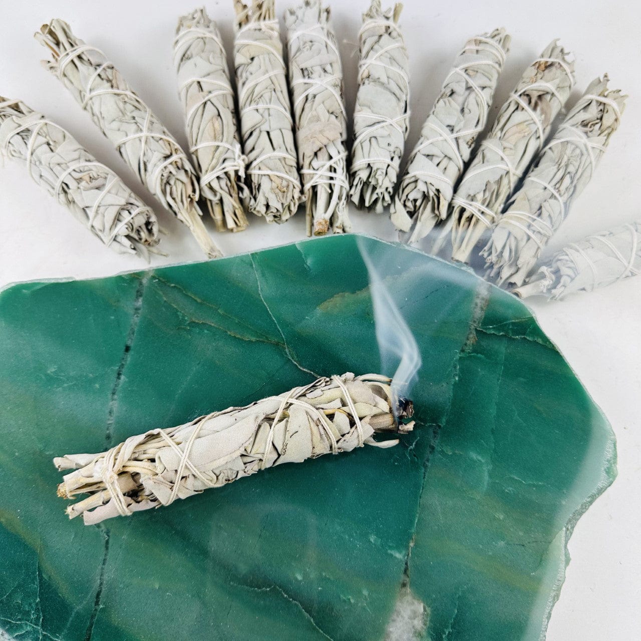 White Sage Sticks -  10 BUNDLES with one on a stone burning