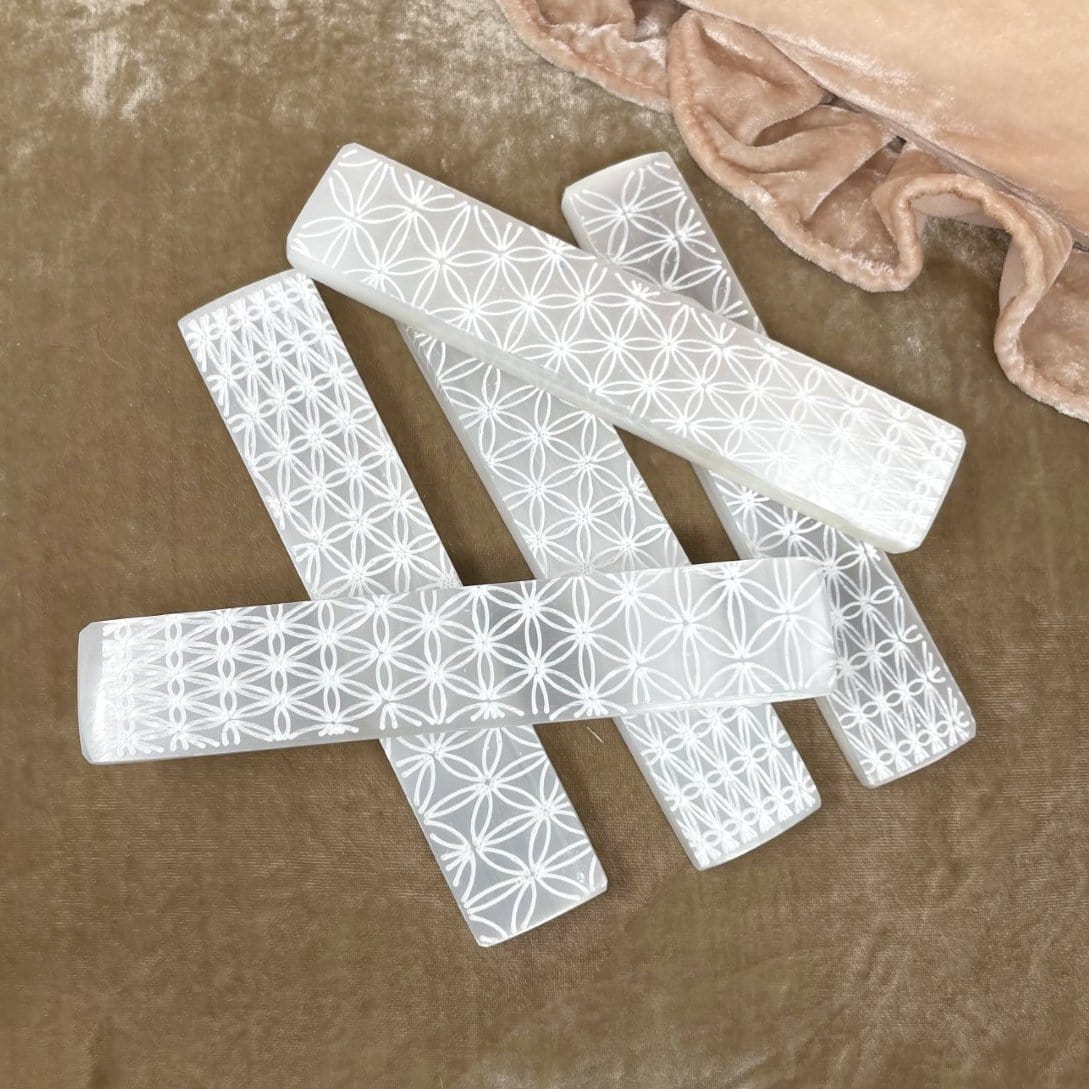 flower of life engraved selenite charging stick on display for possible variations