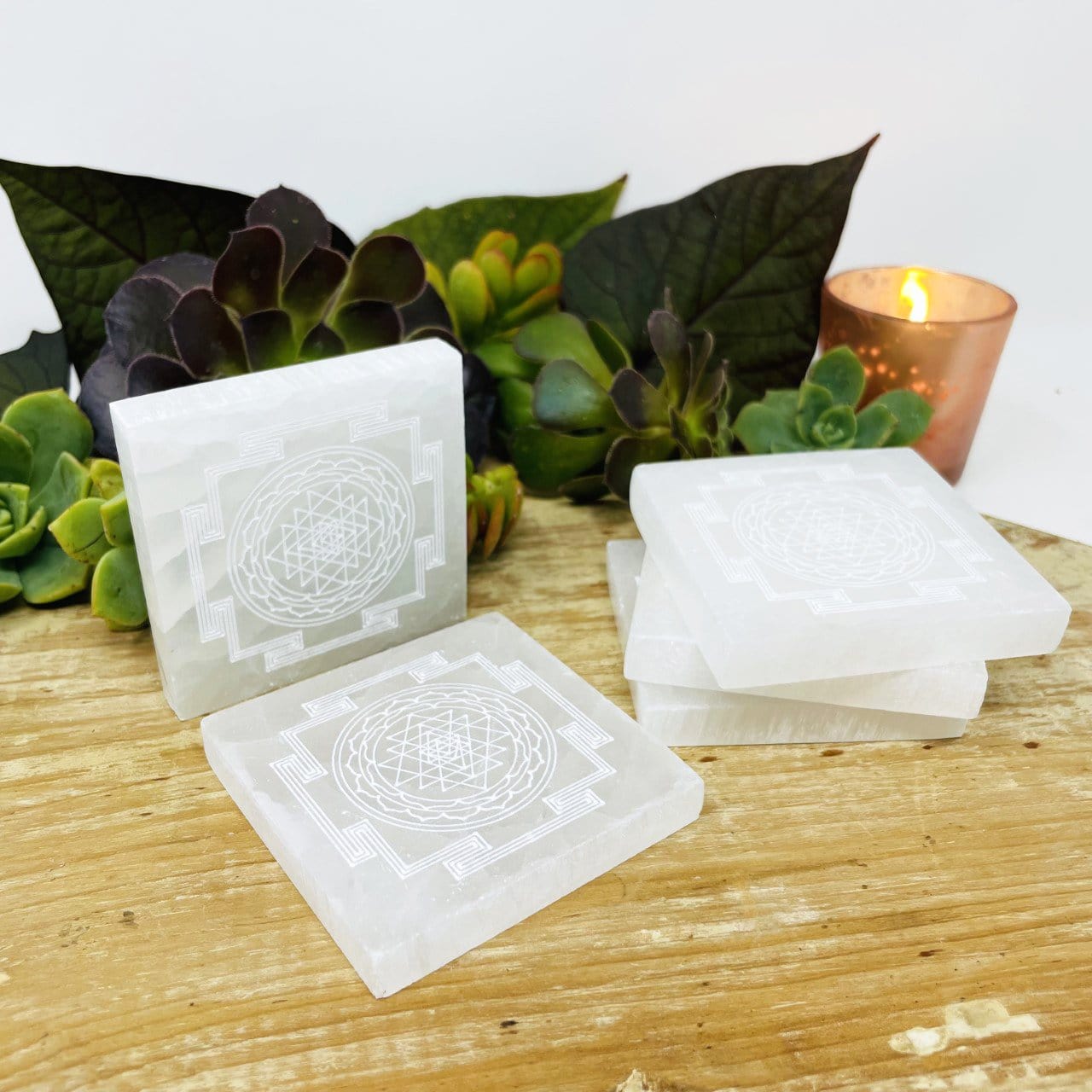 selenite shri yantra mandala engraved square charging plates on display