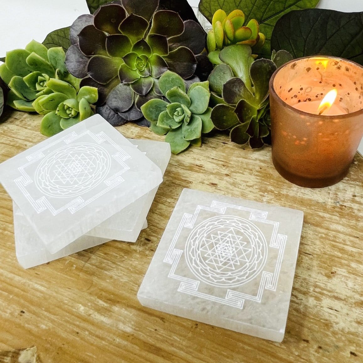 selenite shri yantra mandala engraved square charging plates on display