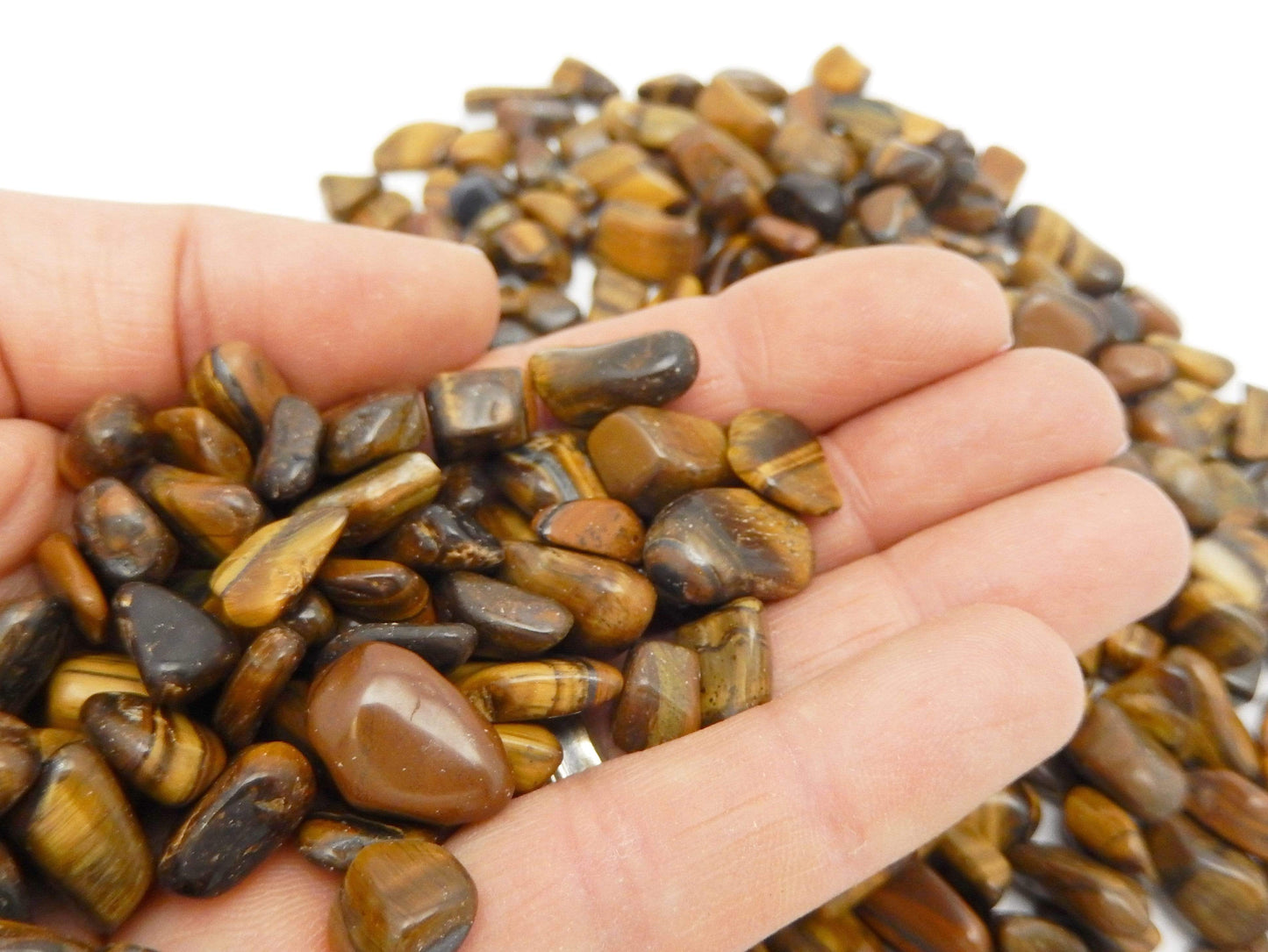 tigers eye stones in hand for size reference 